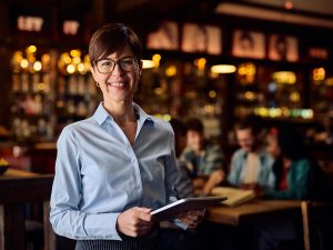 happy-waitress-using-touchpad-while-working-in-a-b-2024-12-13-18-30-47-utc.jpg